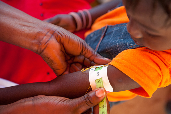Photo of a child's arm being measured in Senegal, 2012. Photo ©Croix-Rouge sénégalaise et française/Guillaume Bassinet